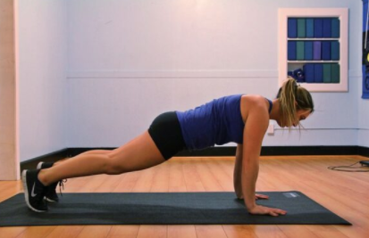 Image of woman doing a plank at the gym