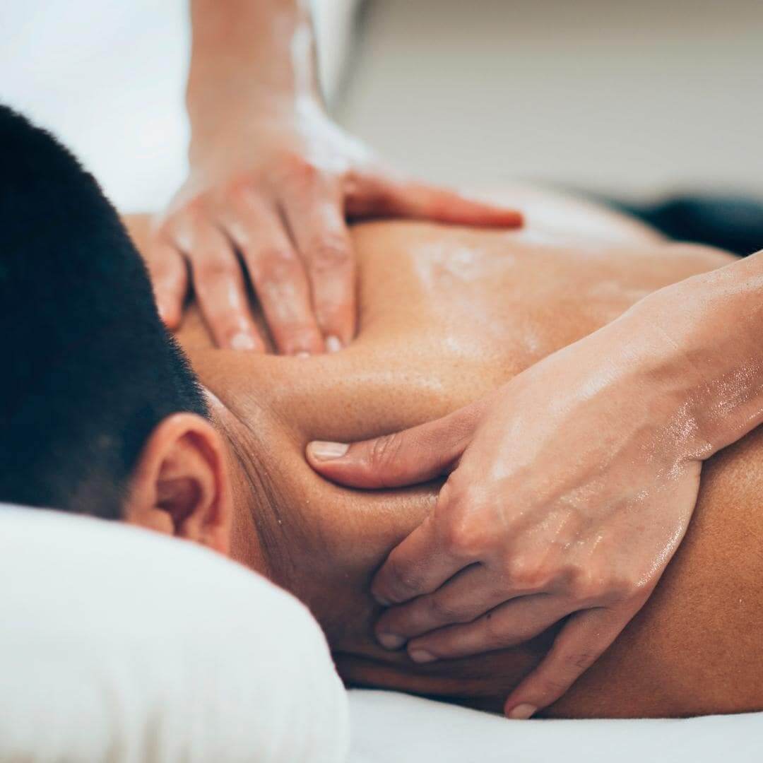 Photo of man getting a shoulder massage in a massage office