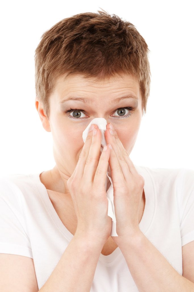 Image of woman blowing her nose