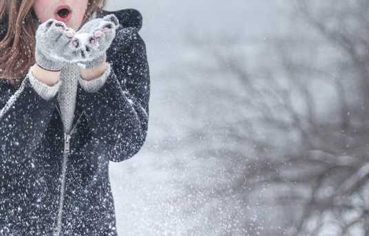 image of woman wearing mittens in the snow
