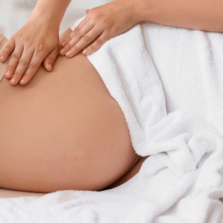 Photo of pregnant person getting a prenatal massage
